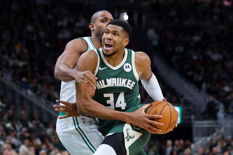 MILWAUKEE, WISCONSIN - NOVEMBER 10: Giannis Antetokounmpo #34 of the Milwaukee Bucks is defended by Al Horford #42 of the Boston Celtics during the first half of a game at Fiserv Forum on November 10, 2024 in Milwaukee, Wisconsin. NOTE TO USER: User expressly acknowledges and agrees that, by downloading and or using this photograph, User is consenting to the terms and conditions of the Getty Images License Agreement. (Photo by Stacy Revere/Getty Images)