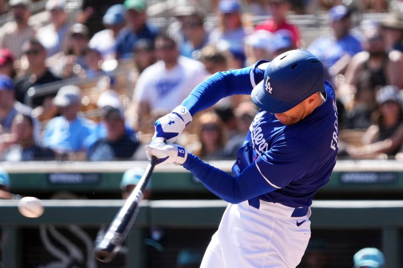 Mar 10, 2024; Phoenix, Arizona, USA; Los Angeles Dodgers first baseman Freddie Freeman (5) hits a home run against the Arizona Diamondbacks during the first inning at Camelback Ranch-Glendale. Mandatory Credit: Joe Camporeale-USA TODAY Sports