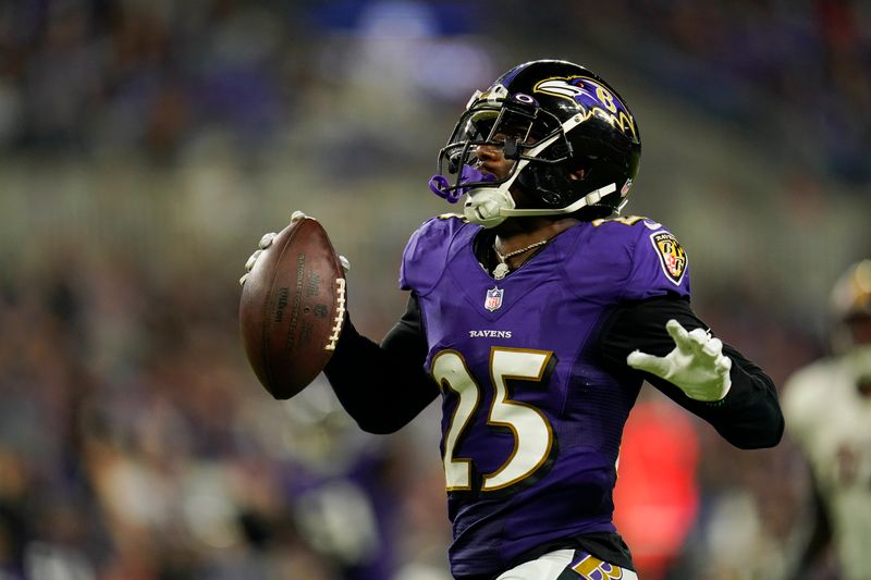 Baltimore Ravens cornerback Kevon Seymour (25) runs with the ball against the Washington Commanders in the second half of a preseason NFL football game, Saturday, Aug. 27, 2022, in Baltimore. (AP Photo/Julio Cortez)