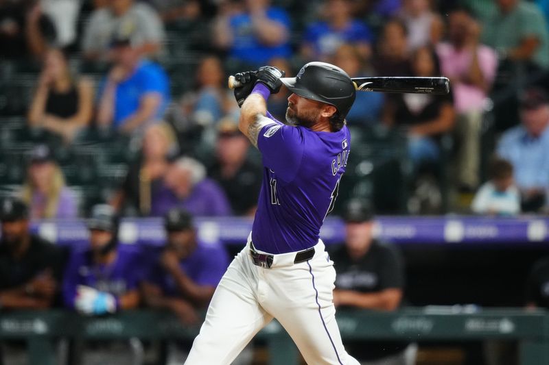 Jul 1, 2024; Denver, Colorado, USA; Colorado Rockies outfielder Jake Cave (11) hits a walk off single in the tenth inning against the Milwaukee Brewers at Coors Field. Mandatory Credit: Ron Chenoy-USA TODAY Sports