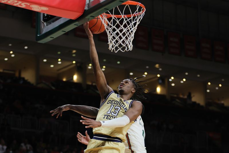 Feb 24, 2024; Coral Gables, Florida, USA; Georgia Tech Yellow Jackets guard Miles Kelly (13) drives to the basket against the Miami Hurricanes during the first half at Watsco Center. Mandatory Credit: Sam Navarro-USA TODAY Sports