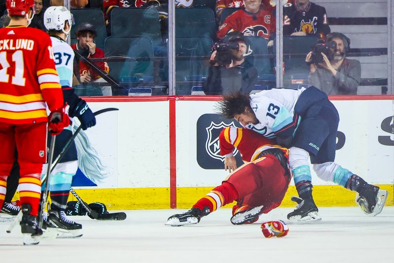 Mar 4, 2024; Calgary, Alberta, CAN; Calgary Flames center Blake Coleman (20) and Seattle Kraken left wing Brandon Tanev (13) fight during the third period at Scotiabank Saddledome. Mandatory Credit: Sergei Belski-USA TODAY Sports