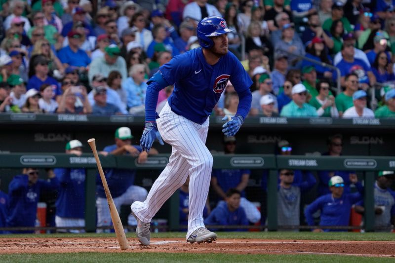 Mar 17, 2024; Mesa, Arizona, USA; Chicago Cubs centerfielder Cody Bellinger (24) hits an RBI sacrifice fly-out in the first inning during a game against the Texas Rangers at Sloan Park. Mandatory Credit: Rick Scuteri-USA TODAY Sports