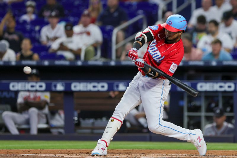 Sep 16, 2023; Miami, Florida, USA; Miami Marlins second baseman Luis Arraez (3) hits a home run against the Atlanta Braves during the first inning at loanDepot Park. Mandatory Credit: Sam Navarro-USA TODAY Sports