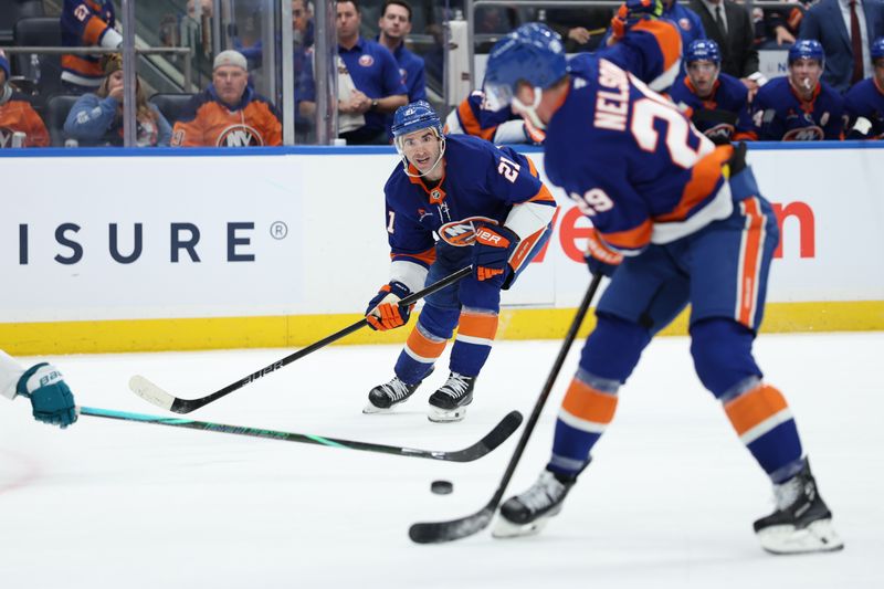 Jan 18, 2025; Elmont, New York, USA;  New York Islanders center Kyle Palmieri (21) makes a pass to New York Islanders center Brock Nelson (29) for the goal against the San Jose Sharks during the second period at UBS Arena. Mandatory Credit: Thomas Salus-Imagn Images