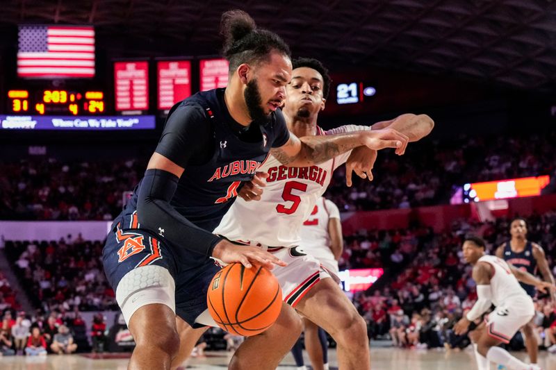 Jan 4, 2023; Athens, Georgia, USA; Auburn Tigers forward Johni Broome (4) dribbles against Georgia Bulldogs center Frank Anselem (5) during the first half at Stegeman Coliseum. Mandatory Credit: Dale Zanine-USA TODAY Sports