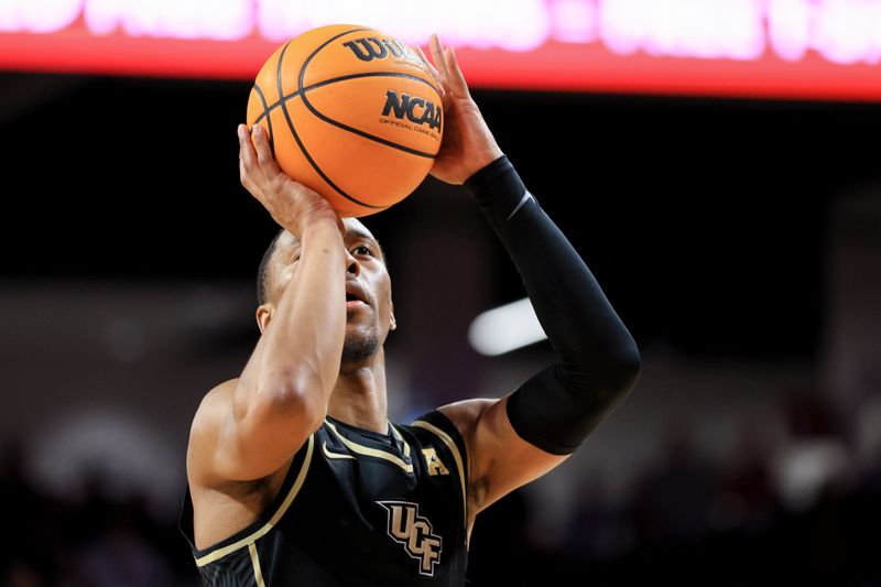 Feb 4, 2023; Cincinnati, Ohio, USA;  UCF Knights guard C.J. Kelly (13) attempts a free throw against the Cincinnati Bearcats in the second half at Fifth Third Arena. Mandatory Credit: Aaron Doster-USA TODAY Sports