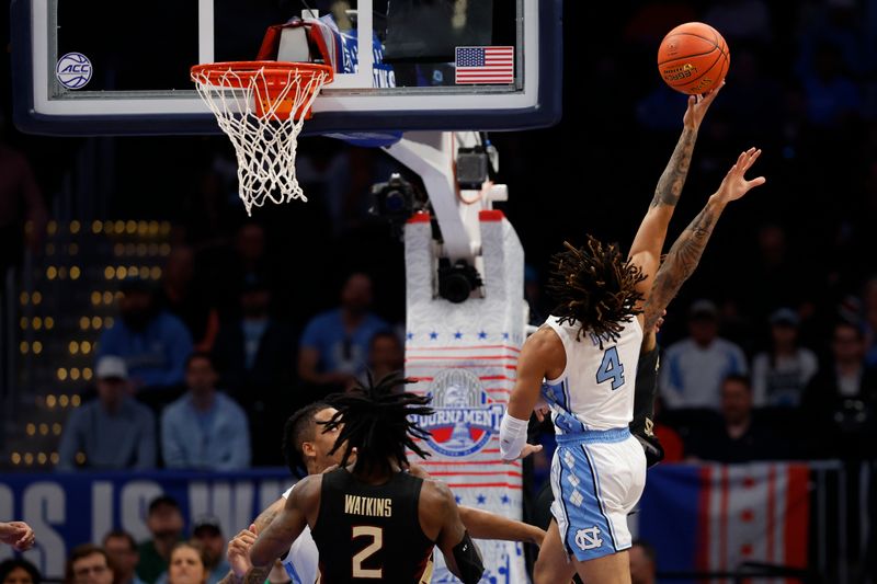 Mar 14, 2024; Washington, D.C., USA; North Carolina guard RJ Davis (4) shoots the ball as Florida State forward Jaylan Gainey (33) defends in the first half at Capital One Arena. Mandatory Credit: Geoff Burke-USA TODAY Sports