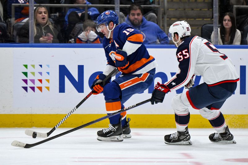 Dec 7, 2023; Elmont, New York, USA; New York Islanders right wing Cal Clutterbuck (15) skates with the puck against Columbus Blue Jackets defenseman David Jiricek (55) during the second period at UBS Arena. Mandatory Credit: John Jones-USA TODAY Sports