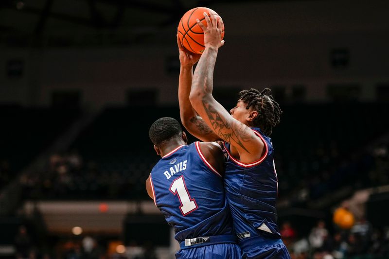 Jan 6, 2024; Charlotte, North Carolina, USA; Florida Atlantic Owls guard Johnell Davis (1) gets hit by forward Isaiah Gaines (5) going for the rebound against the Charlotte 49ers during the first half at Dale F. Halton Arena. Mandatory Credit: Jim Dedmon-USA TODAY Sports