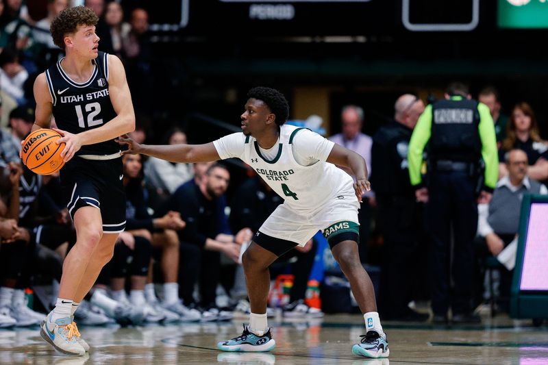 Feb 17, 2024; Fort Collins, Colorado, USA; Utah State Aggies guard Mason Falslev (12) controls the ball against Colorado State Rams guard Isaiah Stevens (4) in the second half at Moby Arena. Mandatory Credit: Isaiah J. Downing-USA TODAY Sports