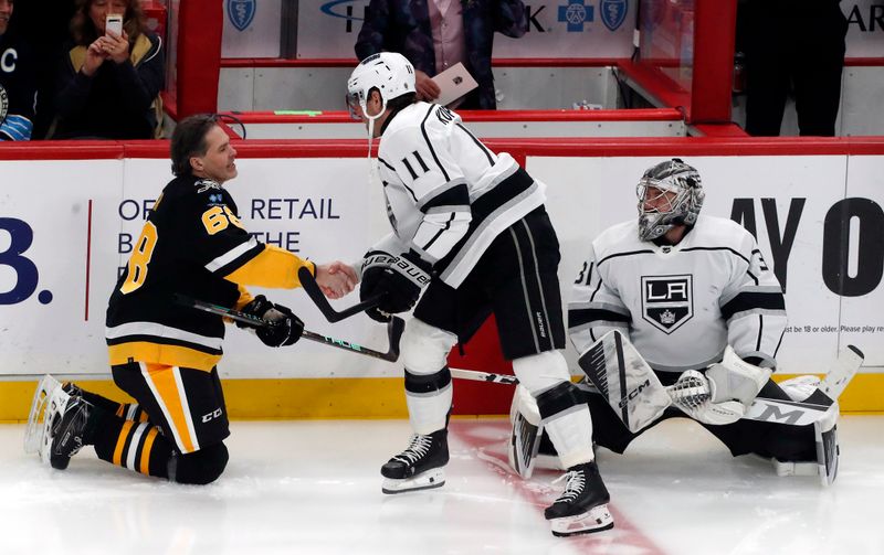 Feb 18, 2024; Pittsburgh, Pennsylvania, USA;  Pittsburgh Penguins former right wing Jaromir Jagr (68) shakes hands with Los Angeles Kings center Anze Kopitar (11) as goaltender Cam Talbot (39) looks on during warm-ups at PPG Paints Arena.The Kings won 2-1.  Mandatory Credit: Charles LeClaire-USA TODAY Sports