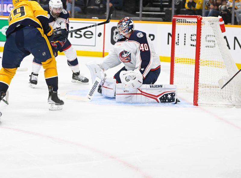 Jan 17, 2023; Nashville, Tennessee, USA;  Columbus Blue Jackets goaltender Daniil Tarasov (40) blocks the shot of Nashville Predators defenseman Roman Josi (59) during the first period at Bridgestone Arena. Mandatory Credit: Steve Roberts-USA TODAY Sports