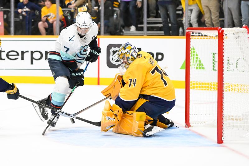 Oct 15, 2024; Nashville, Tennessee, USA;  Nashville Predators goaltender Juuse Saros (74) blocks the shot of Seattle Kraken right wing Jordan Eberle (7) during the second period at Bridgestone Arena. Mandatory Credit: Steve Roberts-Imagn Images