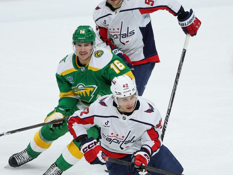 Dec 16, 2025; Saint Paul, Minnesota, USA; Washington Capitals defenseman Martin Fehérváry (42), Minnesota Wild right wing Nicolas Aube-Kubel (16) and center Ethen Frank (53) compete for the puck during the second period at Grand Casino Arena. Mandatory Credit: Matt Krohn-Imagn Images