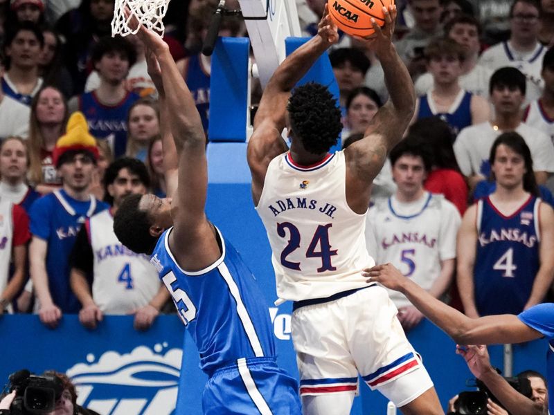 Feb 27, 2024; Lawrence, Kansas, USA; Kansas Jayhawks forward K.J. Adams Jr. (24) shoots as Brigham Young Cougars guard Richie Saunders (15) defends during the first half at Allen Fieldhouse. Mandatory Credit: Denny Medley-USA TODAY Sports