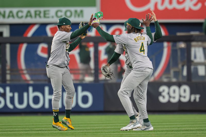 Apr 25, 2024; Bronx, New York, USA; Oakland Athletics left fielder Esteury Ruiz (1) celebrates with center fielder JJ Belday (33) and right fielder Lawrence Butler (4) after defeating the New York Yankees at Yankee Stadium. Mandatory Credit: Vincent Carchietta-USA TODAY Sports