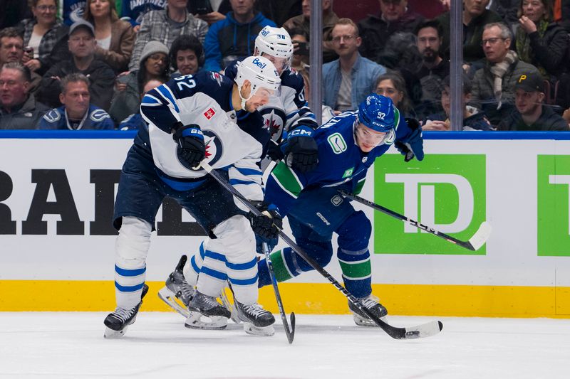 Mar 9, 2024; Vancouver, British Columbia, CAN; Winnipeg Jets defenseman Nate Schmidt (88) and forward Nino Niederreiter (62) battle with Vancouver Canucks forward Vasily Podkolzin (92) in the second period at Rogers Arena. Mandatory Credit: Bob Frid-USA TODAY Sports