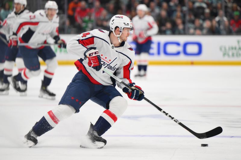 Mar 14, 2024; Seattle, Washington, USA; Washington Capitals center Connor McMichael (24) plays the puck during the first period against the Seattle Kraken at Climate Pledge Arena. Mandatory Credit: Steven Bisig-USA TODAY Sports