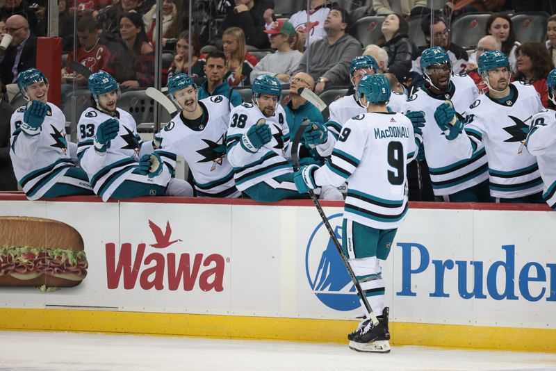 Dec 1, 2023; Newark, New Jersey, USA; San Jose Sharks defenseman Jacob MacDonald (9) celebrates his goal with teammates during the second period against the New Jersey Devils at Prudential Center. Mandatory Credit: Vincent Carchietta-USA TODAY Sports