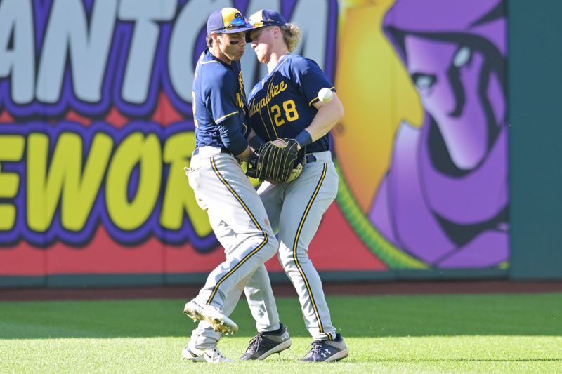 Jun 24, 2023; Cleveland, Ohio, USA; Milwaukee Brewers left fielder Christian Yelich (22) and center fielder Joey Wiemer (28) nearly collide while fielding an RBI hit by Cleveland Guardians second baseman Andres Gimenez (not pictured) during the eighth inning at Progressive Field. Mandatory Credit: Ken Blaze-USA TODAY Sports