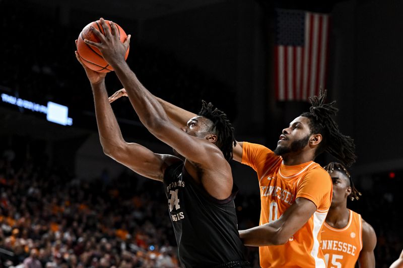 Feb 21, 2023; College Station, Texas, USA;  Tennessee Volunteers forward Jonas Aidoo (0) fouls Texas A&M Aggies forward Julius Marble (34) during the second half at Reed Arena. Mandatory Credit: Maria Lysaker-USA TODAY Sports