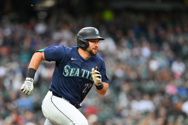 Jun 11, 2024; Seattle, Washington, USA; Seattle Mariners catcher Cal Raleigh (29) runs towards first base after hitting a double against the Chicago White Sox during the third inning at T-Mobile Park. Mandatory Credit: Steven Bisig-USA TODAY Sports