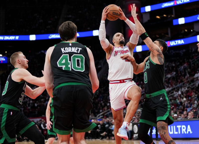 HOUSTON, TEXAS - JANUARY 21: Dillon Brooks #9 of the Houston Rockets drives to the basket as Jayson Tatum #0 of the Boston Celtics defends during the third quarter of the game at Toyota Center on January 21, 2024 in Houston, Texas. NOTE TO USER: User expressly acknowledges and agrees that, by downloading and or using this photograph, User is consenting to the terms and conditions of the Getty Images License Agreement. (Photo by Alex Bierens de Haan/Getty Images)