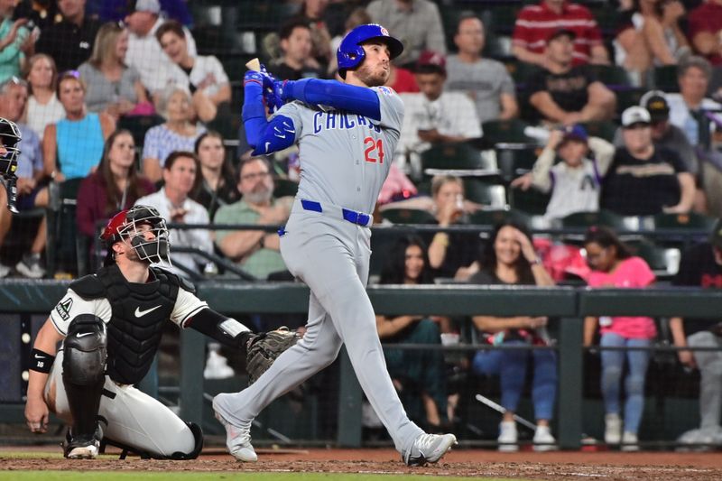 Apr 17, 2024; Phoenix, Arizona, USA;  Chicago Cubs outfielder Cody Bellinger (24) hits a solo home run in the sixth inning against the Arizona Diamondbacks at Chase Field. Mandatory Credit: Matt Kartozian-USA TODAY Sports