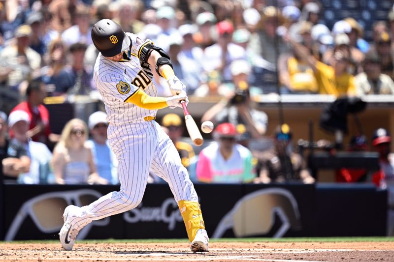 Jun 26, 2024; San Diego, California, USA; San Diego Padres catcher Kyle Higashioka (20) hits a two-run home run against the Washington Nationals during the second inning at Petco Park. Mandatory Credit: Orlando Ramirez-USA TODAY Sports