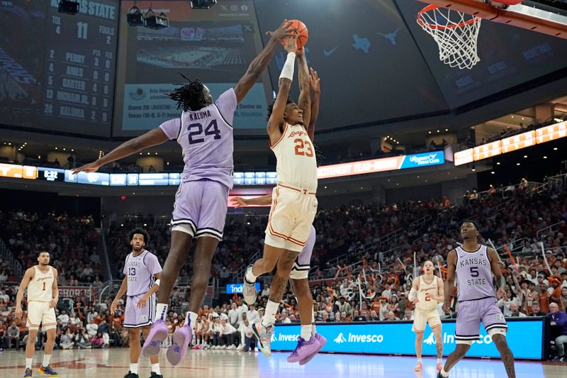 Feb 19, 2024; Austin, Texas, USA; Texas Longhorns forward Dillon Mitchell (23) goes up to dunk while defended by Kansas State Wildcats forward Arthur Kaluma (24) during the first half at Moody Center. Mandatory Credit: Scott Wachter-USA TODAY Sports