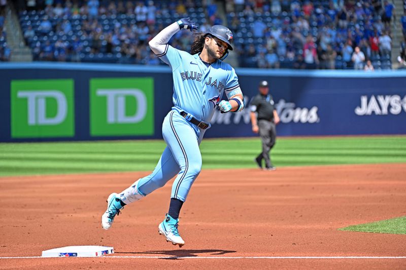 Jun 1, 2023; Toronto, Ontario, CAN; Toronto Blue Jays shortstop Bo Bichette (11) rounds third base after hitting a solo home run against the Milwaukee Brewers in the first  inning at Rogers Centre. Mandatory Credit: Dan Hamilton-USA TODAY Sports