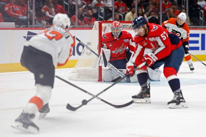 Sep 22, 2024; Washington, District of Columbia, USA; Washington Capitals goaltender Clay Stevenson (33) prepares to make a save on Philadelphia Flyers forward Jett Luchanko (17) Capitals forward Trevor van Riemsdyk (57) defends in the second period at Capital One Arena. Mandatory Credit: Geoff Burke-Imagn Images