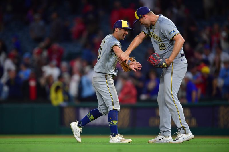 Jun 18, 2024; Anaheim, California, USA; Milwaukee Brewers outfielder Sal Frelick (10) and pitcher Trevor Megill (29) celebrate the victory against the Los Angeles Angels at Angel Stadium. Mandatory Credit: Gary A. Vasquez-USA TODAY Sports