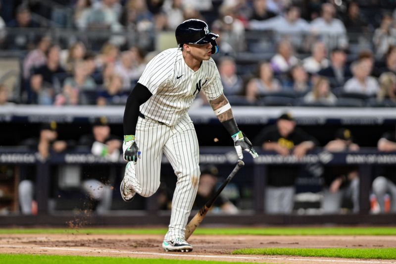 Sep 27, 2024; Bronx, New York, USA; New York Yankees second baseman Gleyber Torres (25) hits a single against the Pittsburgh Pirates during the third inning at Yankee Stadium. Mandatory Credit: John Jones-Imagn Images