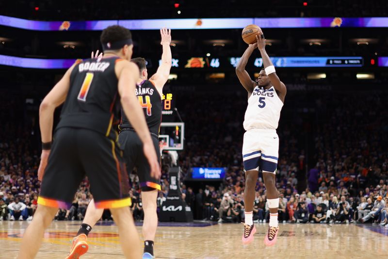 PHOENIX, ARIZONA - APRIL 26: Anthony Edwards #5 of the Minnesota Timberwolves attempts a shot over Drew Eubanks #14 of the Phoenix Suns during the first half of game three of the Western Conference First Round Playoffs at Footprint Center on April 26, 2024 in Phoenix, Arizona. NOTE TO USER: User expressly acknowledges and agrees that, by downloading and or using this photograph, User is consenting to the terms and conditions of the Getty Images License Agreement. NOTE TO USER: User expressly acknowledges and agrees that, by downloading and or using this photograph, User is consenting to the terms and conditions of the Getty Images License Agreement. ? (Photo by Christian Petersen/Getty Images)