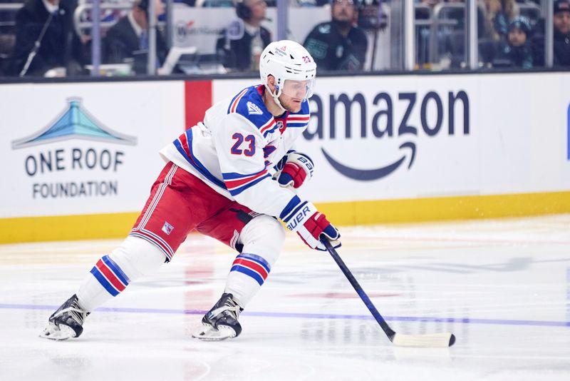Nov 1, 2025; Seattle, Washington, USA;  New York Rangers defenseman Adam Fox (23) controls the puck during the third period against the Seattle Kraken at Climate Pledge Arena. Mandatory Credit: Blake Dahlin-Imagn Images