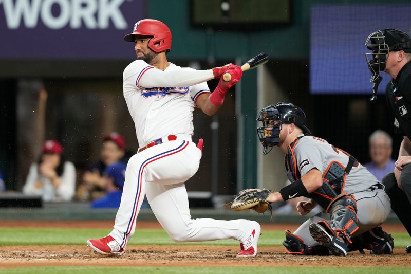 Jun 27, 2023; Arlington, Texas, USA; Texas Rangers left fielder Ezequiel Duran (20) follows through on his single against the Detroit Tigers during the sixth inning at Globe Life Field. Mandatory Credit: Jim Cowsert-USA TODAY Sports