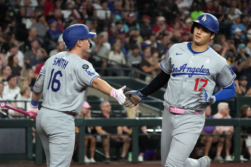 May 11, 2025; Phoenix, Arizona, USA; Los Angeles Dodgers Shohei Ohtani (17) celebrates with Will Smith (16) after scoring a run against the Arizona Diamondbacks in the fifth inning at Chase Field. Mandatory Credit: Rick Scuteri-Imagn Images