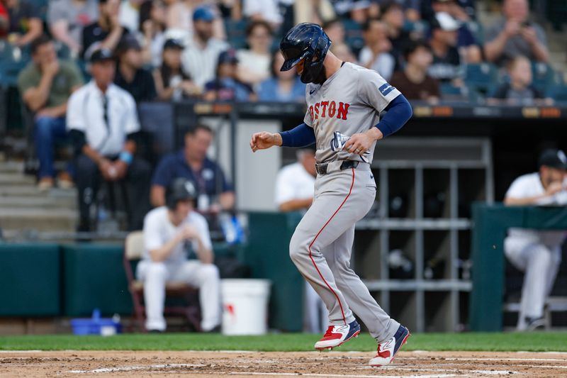 Jun 6, 2024; Chicago, Illinois, USA; Boston Red Sox catcher Connor Wong (12) scores against the Chicago White Sox during the second inning at Guaranteed Rate Field. Mandatory Credit: Kamil Krzaczynski-USA TODAY Sports