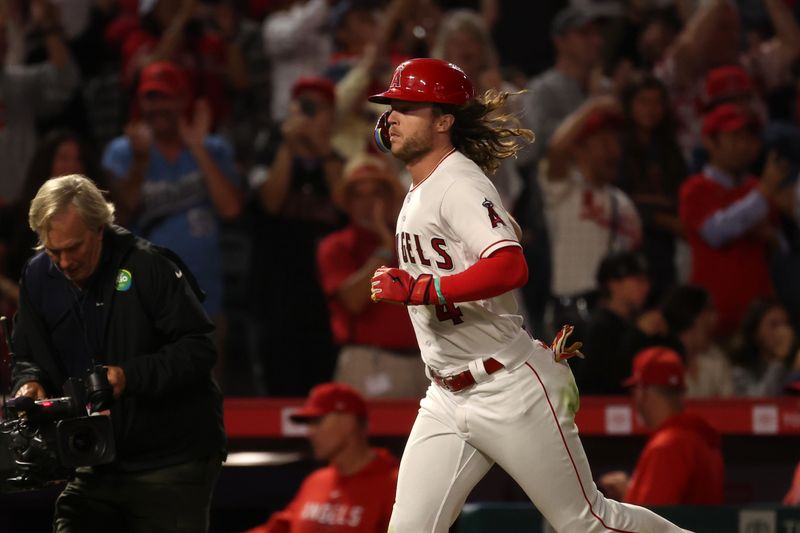 Sep 16, 2023; Anaheim, California, USA;  Los Angeles Angels center fielder Brett Phillips (4) scores a run on a solo home run during the ninth inning against the Detroit Tigers at Angel Stadium. Mandatory Credit: Kiyoshi Mio-USA TODAY Sports