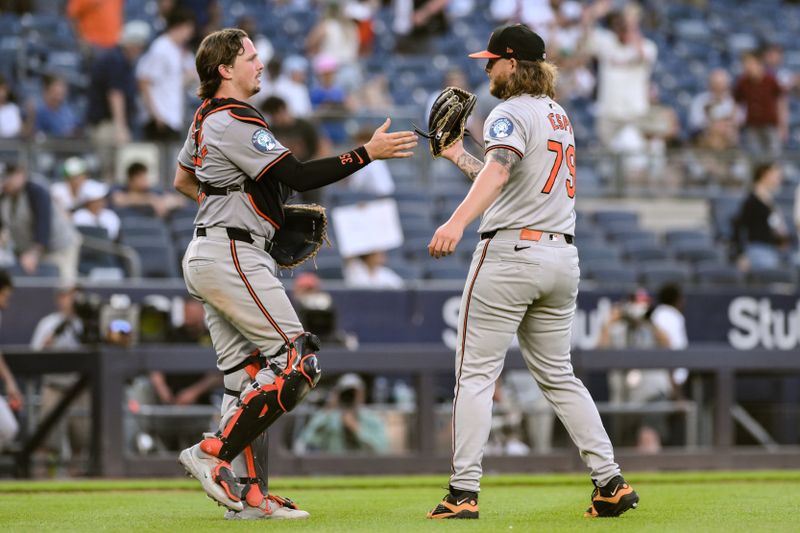 Jun 20, 2024; Bronx, New York, USA; Baltimore Orioles catcher Adley Rutschman (35) greets pitcher Nick Vespi (79) after the final out against the New York Yankees at Yankee Stadium. Mandatory Credit: John Jones-USA TODAY Sports