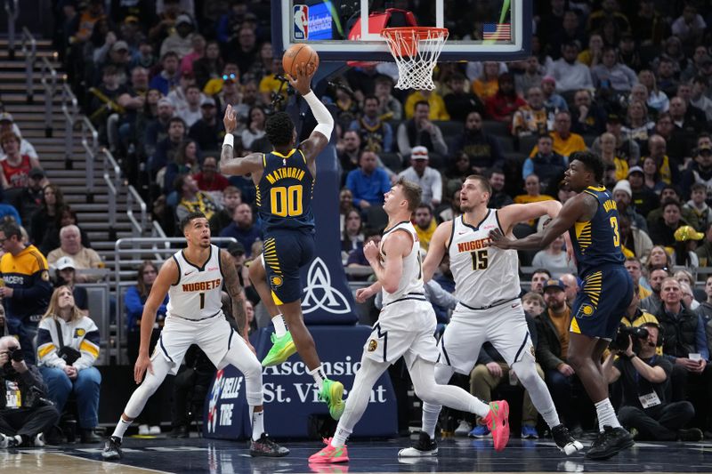 INDIANAPOLIS, INDIANA - FEBRUARY 24: Bennedict Mathurin #00 of the Indiana Pacers attempts a shot while being guarded by Christian Braun #0 of the Denver Nuggets in the first quarter at Gainbridge Fieldhouse on February 24, 2025 in Indianapolis, Indiana. NOTE TO USER: User expressly acknowledges and agrees that, by downloading and or using this photograph, User is consenting to the terms and conditions of the Getty Images License Agreement. (Photo by Dylan Buell/Getty Images)