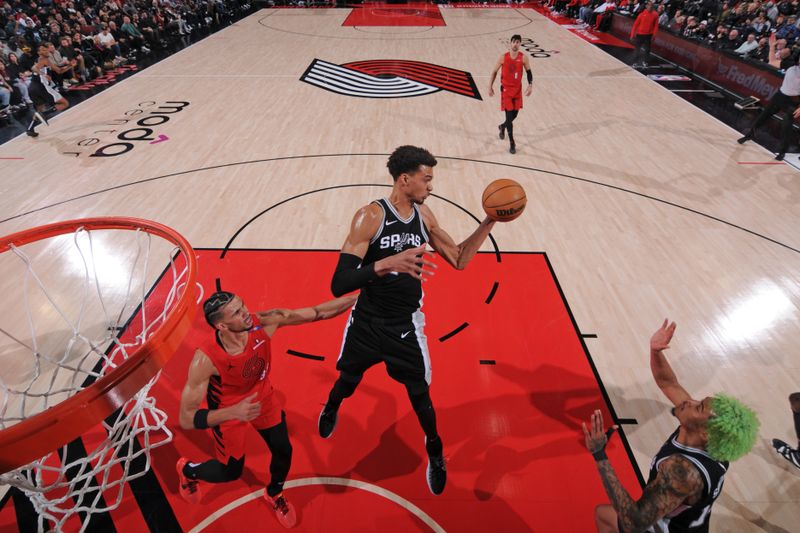 PORTLAND, OR - DECEMBER 13: Victor Wembanyama #1 of the San Antonio Spurs grabs the rebound during the game against the Portland Trail Blazers on December 13, 2024 at the Moda Center Arena in Portland, Oregon. NOTE TO USER: User expressly acknowledges and agrees that, by downloading and or using this photograph, user is consenting to the terms and conditions of the Getty Images License Agreement. Mandatory Copyright Notice: Copyright 2024 NBAE (Photo by Cameron Browne/NBAE via Getty Images)