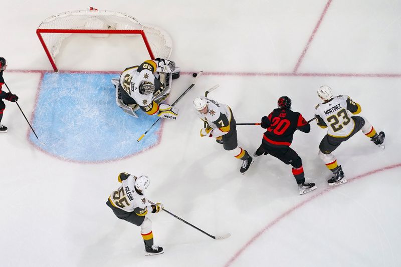 Mar 11, 2023; Raleigh, North Carolina, USA; Carolina Hurricanes center Sebastian Aho (20) shot is stopped by Vegas Golden Knights goaltender Jonathan Quick (32) during the third period at PNC Arena. Mandatory Credit: James Guillory-USA TODAY Sports