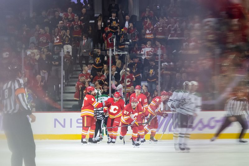 Nov 22, 2025; Calgary, Alberta, CAN; Calgary Flames right wing Matt Coronato (27) and teammates celebrate a goal against the Dallas Stars during the first period at Scotiabank Saddledome. Mandatory Credit: Brett Holmes-Imagn Images