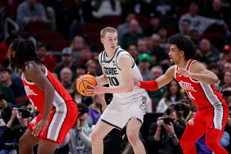 Mar 10, 2023; Chicago, IL, USA; Michigan State Spartans forward Joey Hauser (10) looks to pass the ball against Ohio State Buckeyes forward Justice Sueing (14) during the first half at United Center. Mandatory Credit: Kamil Krzaczynski-USA TODAY Sports