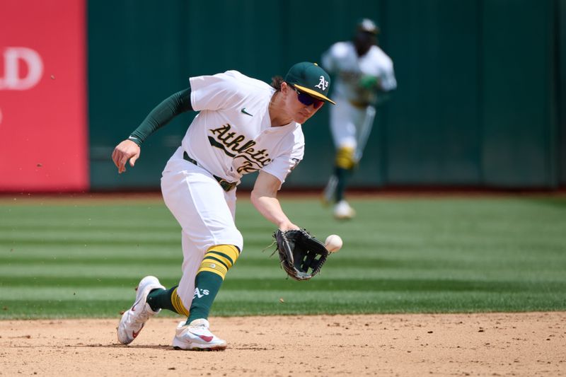 Apr 14, 2024; Oakland, California, USA; Oakland Athletics second baseman Zack Gelof (20) fields a ground ball against the Washington Nationals during the fifth inning at Oakland-Alameda County Coliseum. Mandatory Credit: Robert Edwards-USA TODAY Sports