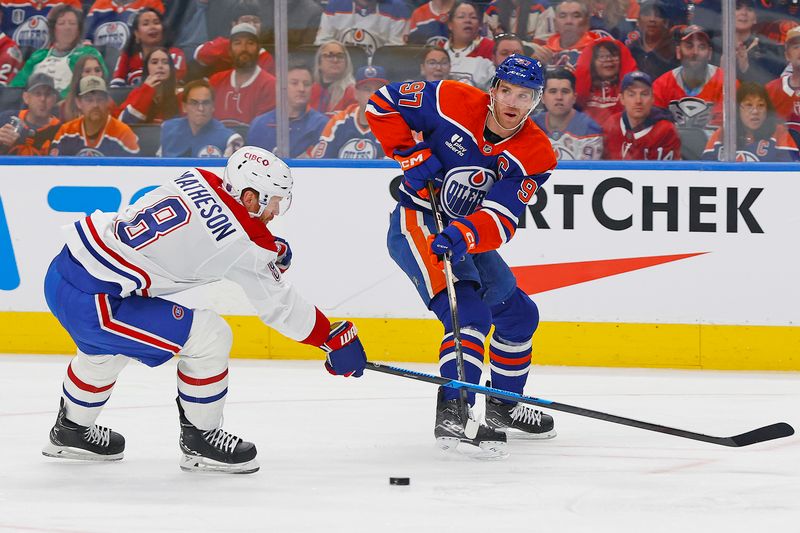 Oct 23, 2025; Edmonton, Alberta, CAN; Edmonton Oilers forward Connor McDavid (97) makes a pass in front of Montreal Canadiens defensemen Mike Matheson (8) during the first period at Rogers Place. Mandatory Credit: Perry Nelson-Imagn Images