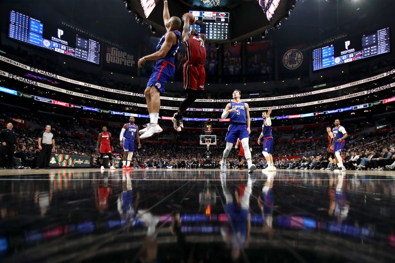 LOS ANGELES, CALIFORNIA - JANUARY 02: Bam Adebayo #13 of the Miami Heat dunks the ball against Nicolas Batum #33 of the Los Angeles Clippers during the fourth quarter  at Crypto.com Arena on January 02, 2023 in Los Angeles, California. NOTE TO USER: User expressly acknowledges and agrees that, by downloading and or using this photograph, User is consenting to the terms and conditions of the Getty Images License Agreement. (Photo by Katelyn Mulcahy/Getty Images)